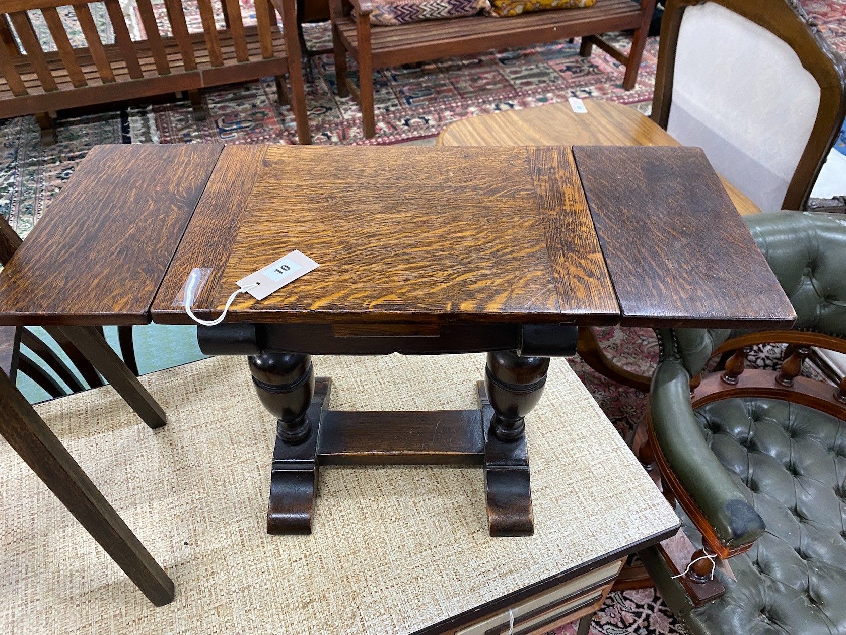 A 1920's small oak draw leaf occasional table, width 41cm, depth 29cm, height 44cm together with an Edwardian oak two tier plant stand